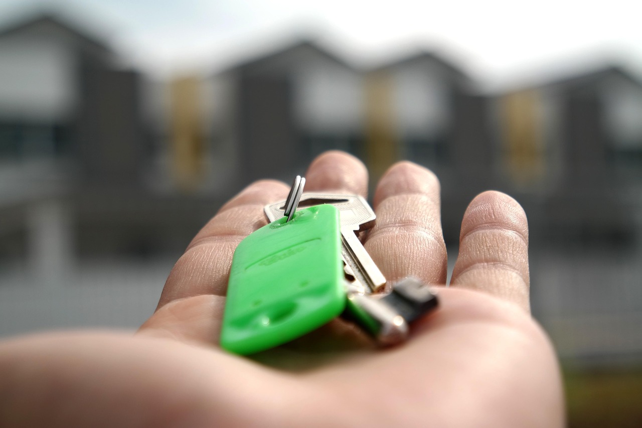 House keys being handed across a desk