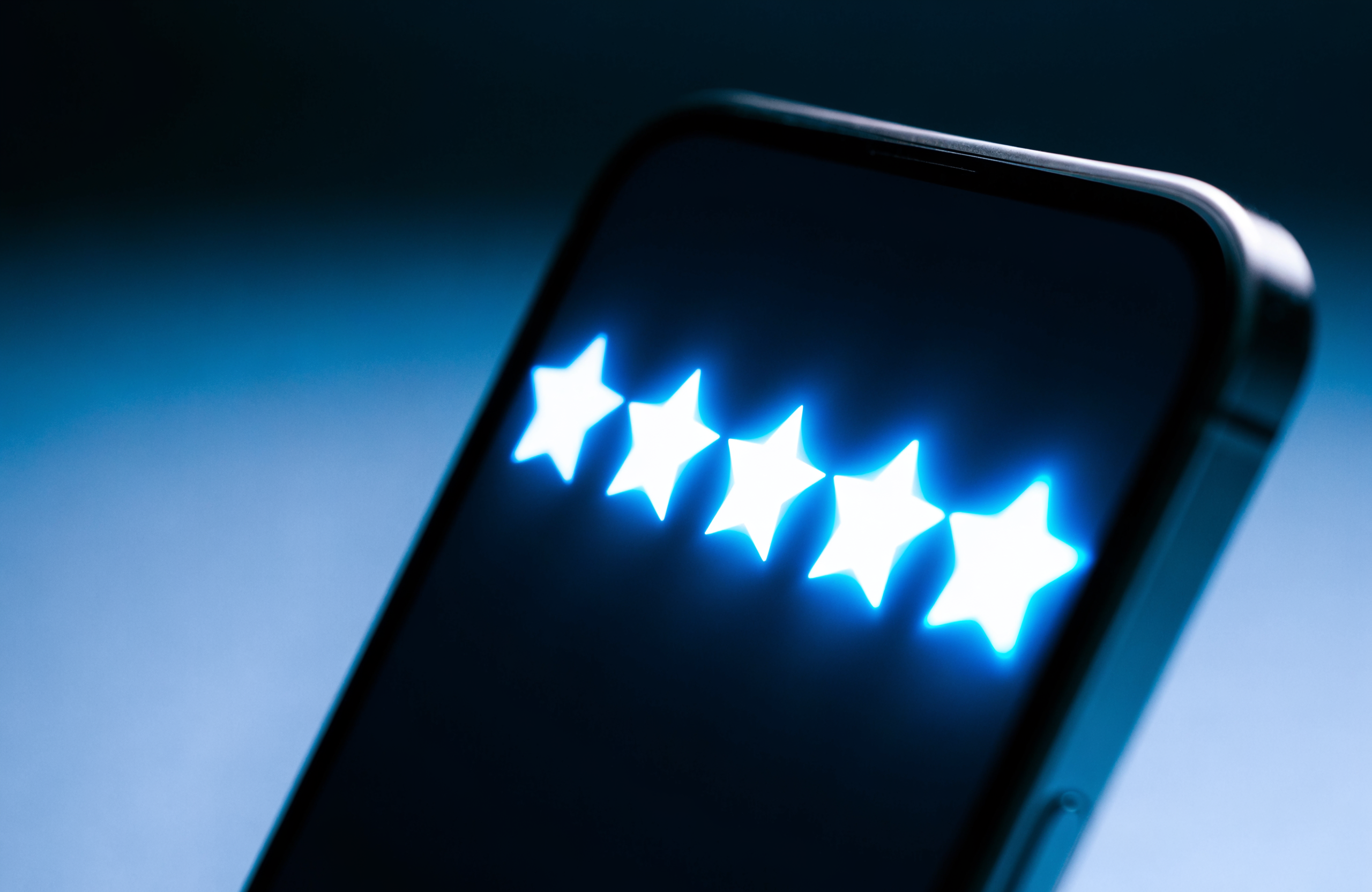 A smartphone screen glowing with five star rating icons in electric blue, styled in Wise Media brand colors, representing Google Business Profile reviews