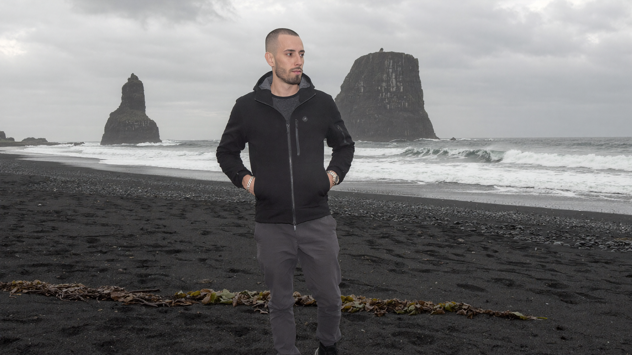A black sand beach under heavy overcast, flat light that removes the burden of tracking shadow direction