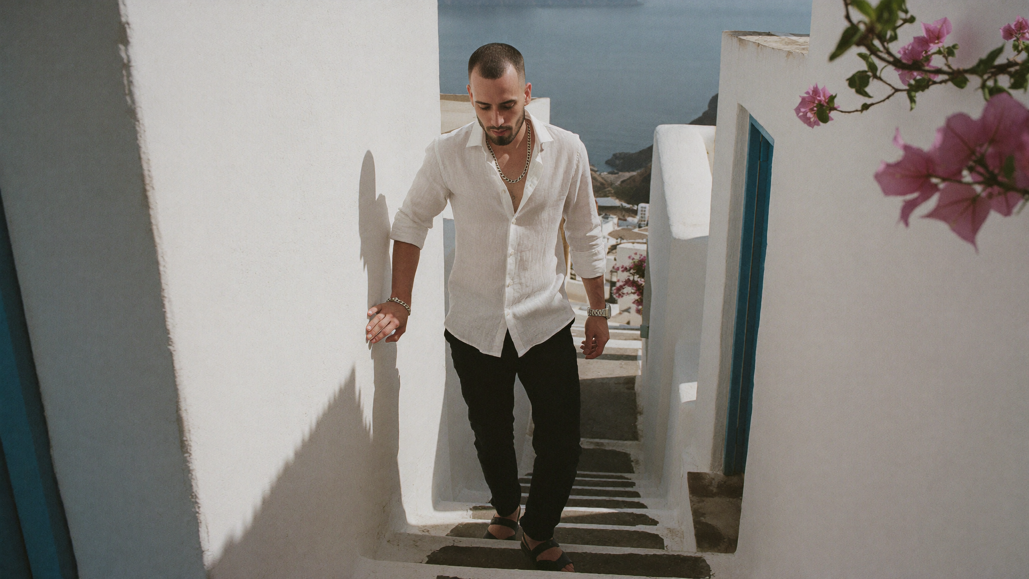 A whitewashed stepped alleyway composed so the repeating geometry does not have room to drift