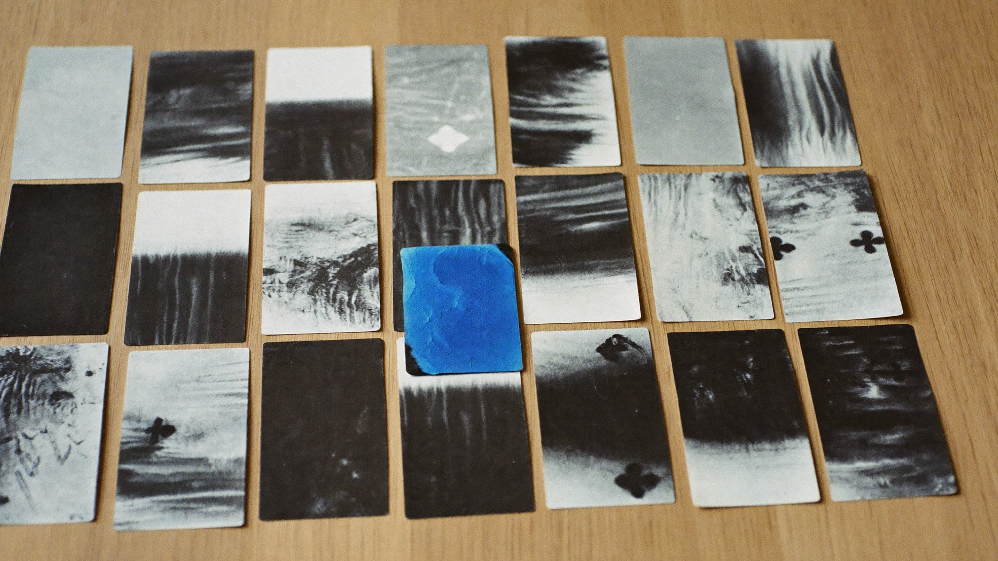 Paint chip cards in a grid, a monochrome run with two blue cards placed as accents