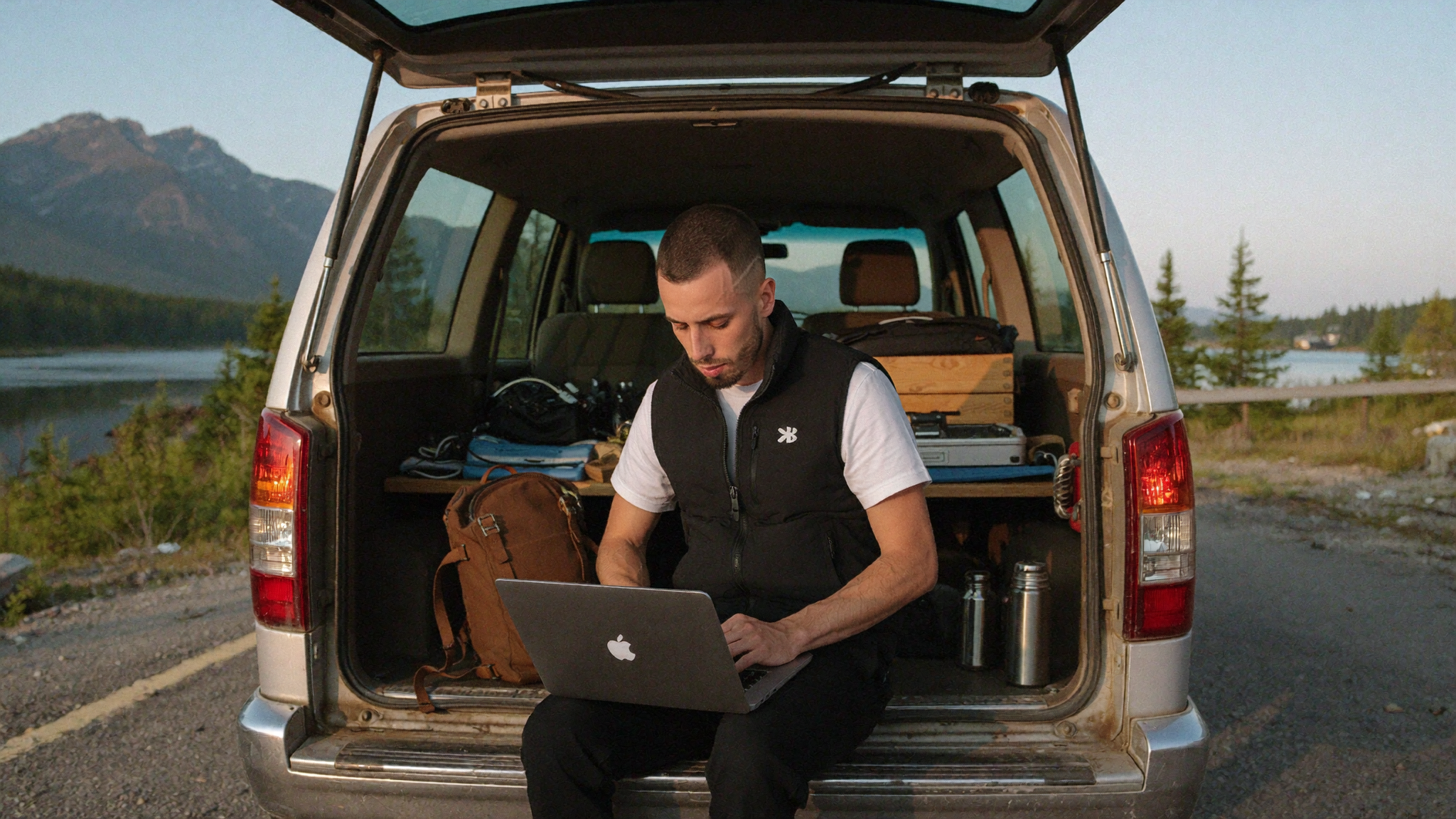 Property operator working from a camper van tailgate calculating direct booking break-even