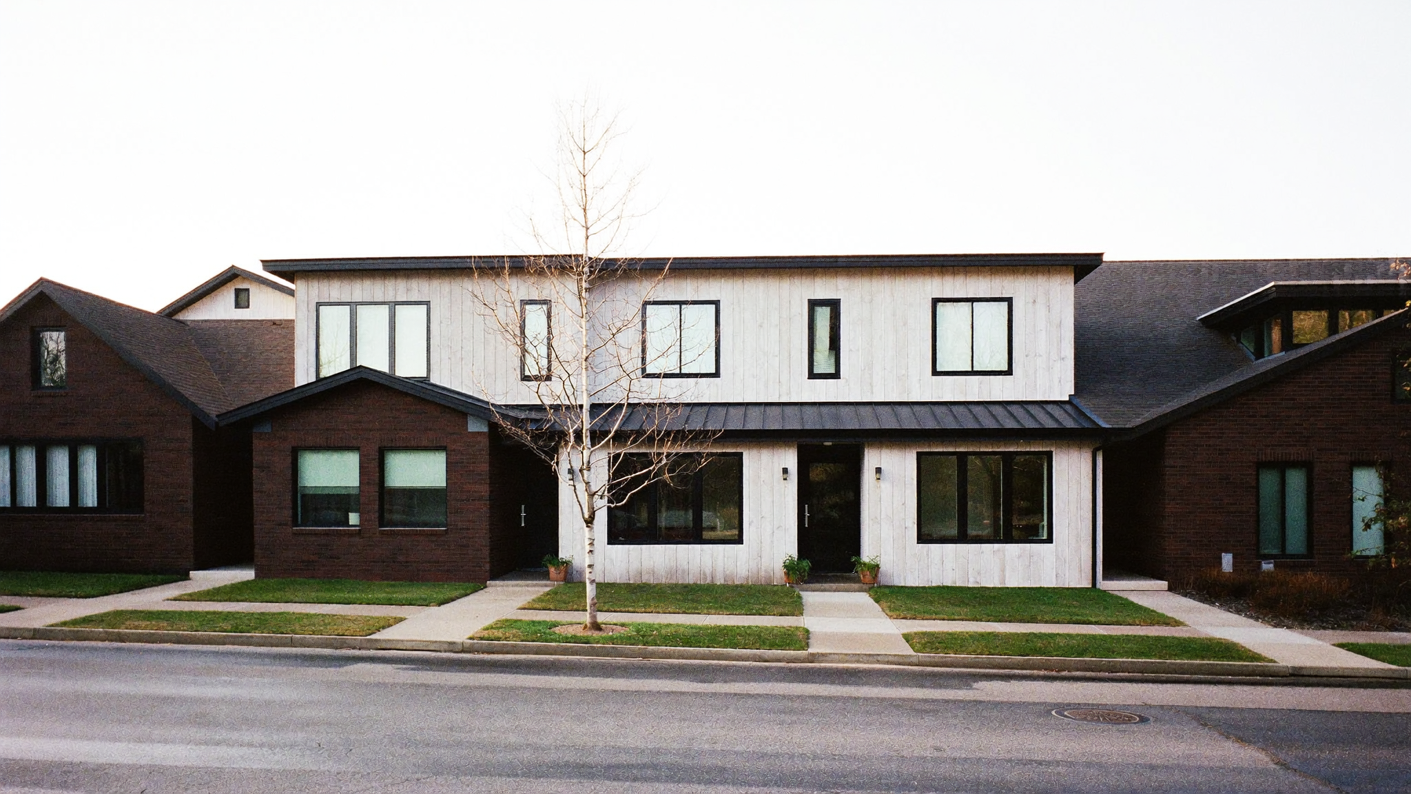 A row of townhouses on a quiet street, typical of the property types discussed in tokenization pilots