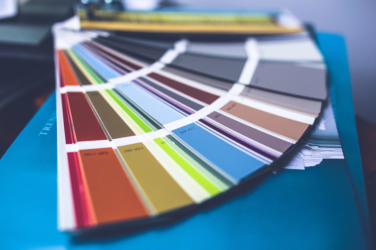 A fanned-out colour swatch deck, representing the primary and secondary colour palette delivered in a brand identity package.