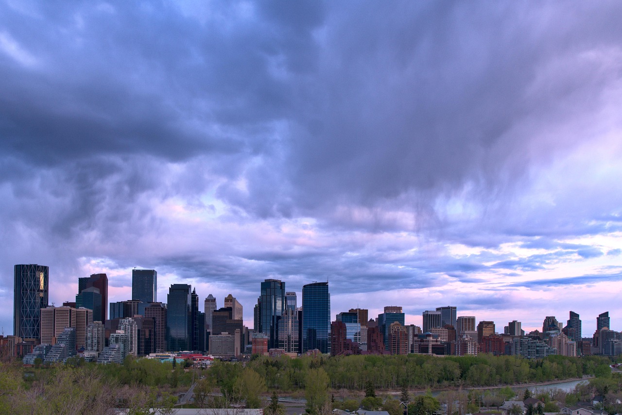 The Calgary skyline under heavy cloud, representing the Canadian advertisers now eligible to buy ChatGPT ads through the self serve Ads Manager.