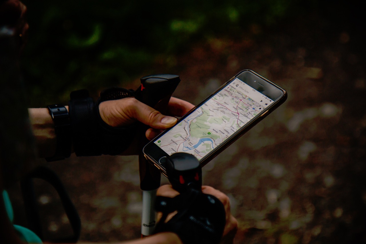 A hand holding a phone showing a map, the moment a customer compares nearby businesses by star rating before choosing one.