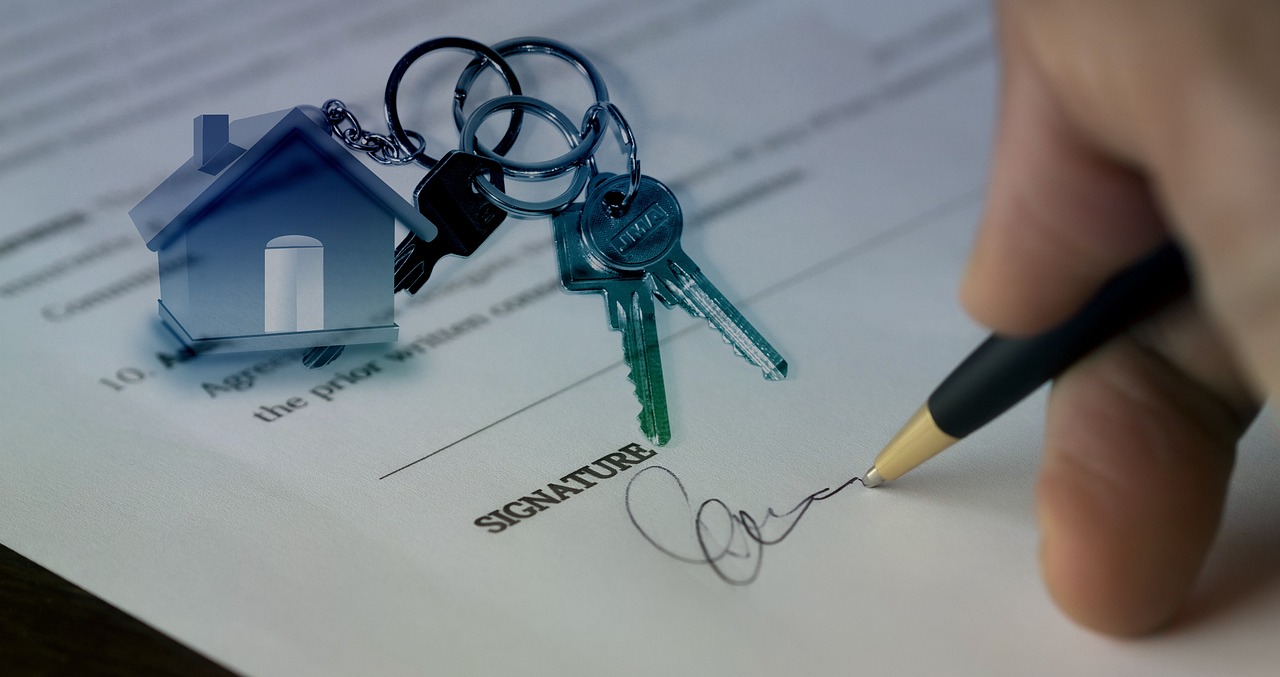 House keys resting on a purchase contract being signed, the transaction an AI-assisted property search is meant to lead to.