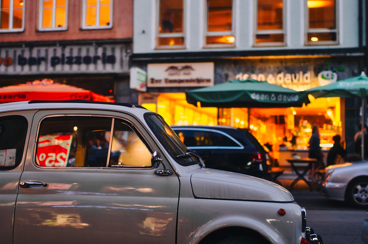 A small business storefront lit at dusk on a city street, illustrating local search visibility for a physical location.