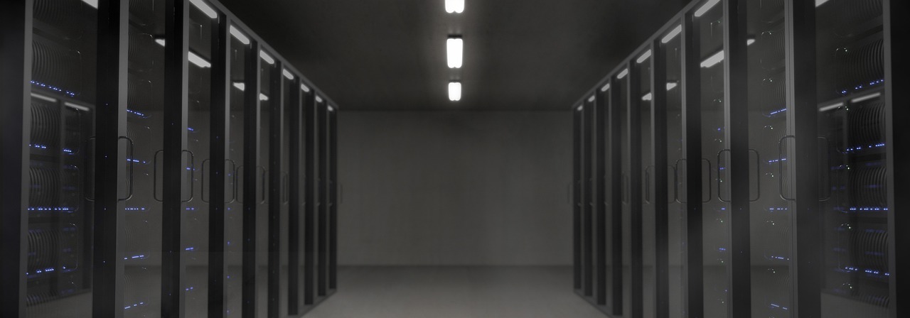 Rows of data centre servers, representing the MLS and DDF feeds that supply Canadian real estate listing data to third-party platforms.