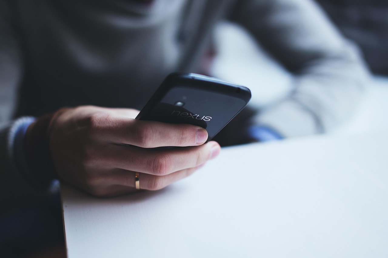 A hand holding a smartphone, illustrating how little of a page fits on a mobile first screen before scrolling.