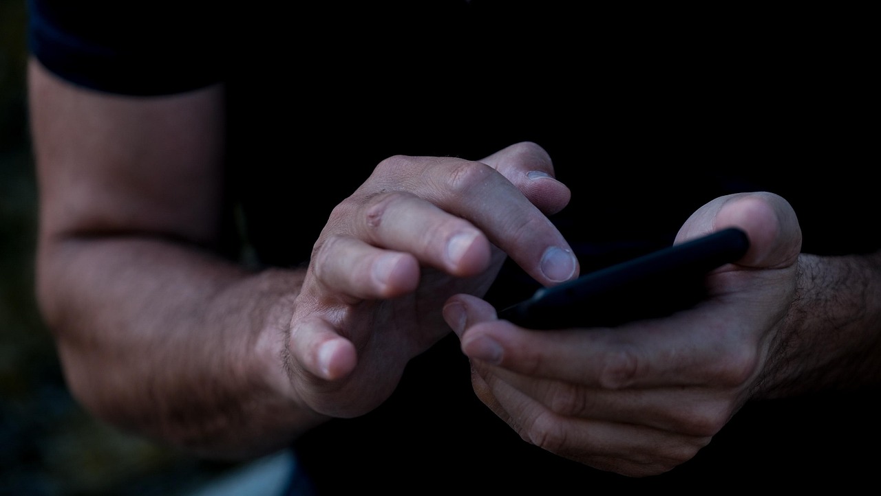 A person holding a smartphone, the device most Canadian service business enquiries are now submitted from